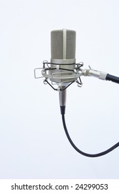 A Recording Boom Mic Pointing Up On A White Background