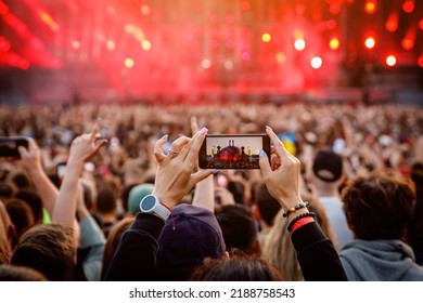 Recording a concert using a mobile phone. Smartphone at music show