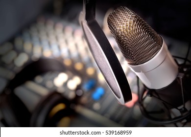 Recording Equipment In Studio. Studio Microphone With Headphones And Mixer Background. Elevated View