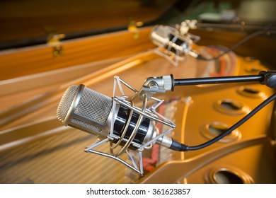 Recording microphone above grand piano.