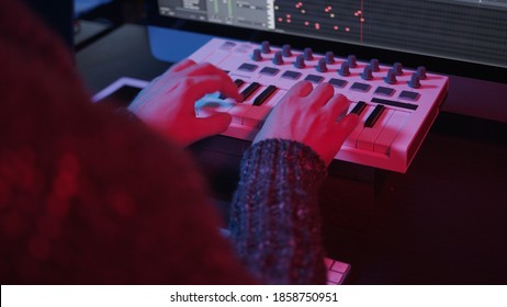 Recording Music Notes, Playing Electronic Keyboard, Midi Keys In Music Sequencer. Hands And Midi Controller On The Table With Neon Lights, Man Composing Music In Night