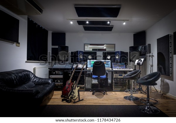 Recording studio control\
room complete with mixing desk, computer and outboard equipment.\
Also in the image are guitars, keyboard, microphone and\
synthesisers.
