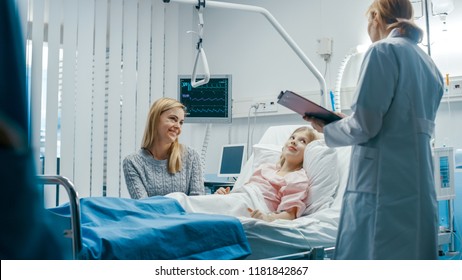 Recovering Little Girl Lies on a Bed In the Hospital, Friendly Doctor With Clipboard Asks Where it Hurts, Mother Sits Beside Bed. Cute Child in the Modern Pediatric/ Children Ward. - Powered by Shutterstock