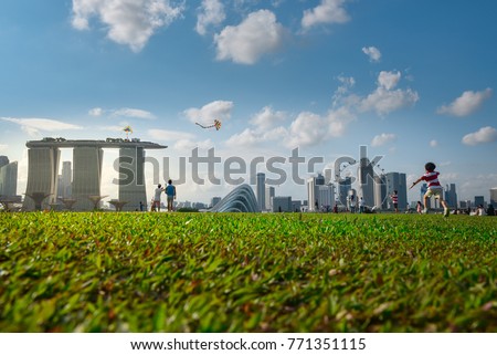 
Recreation area in Marina Barrage, a dam in Singapore with singapore city view where people, including coup are social gathering 