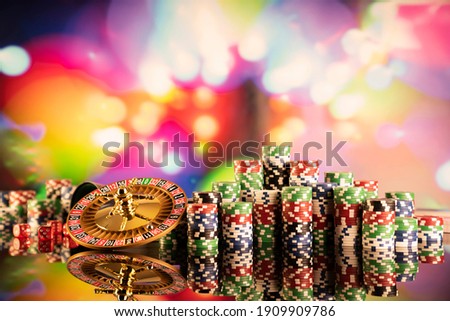 Recreation and entertainment. Casino concept. Roulette, poker, dice. Bokeh background.