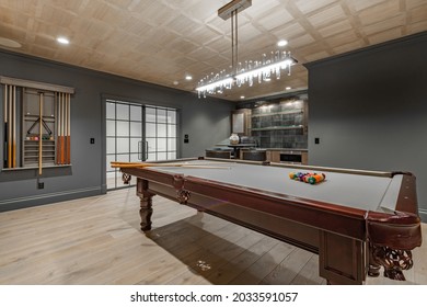 recreation room with large wooden pool table and glass doors