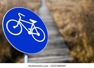 Recreation walk and cycle path road sign. Round blue information sign. Ubran area road safe to walk. Traffic sign isolated. Weekend recreation outdoor background.