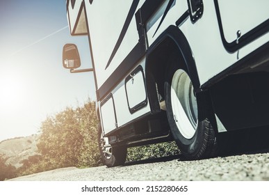 Recreational Class C Motorhome Vehicle on the Side of a Road. Summer Family Rving Theme. Road Trip Concept.