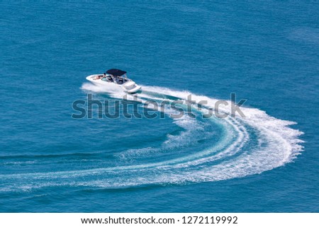Recreational high speed motorboat makes sudden turn at sea