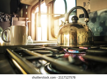 Recreational Vehicle Kitchen. Stovetop Modern Whistling Tea Kettle Stainless Steel Made. Boiling Water Inside RV Motohome Camper Van. 