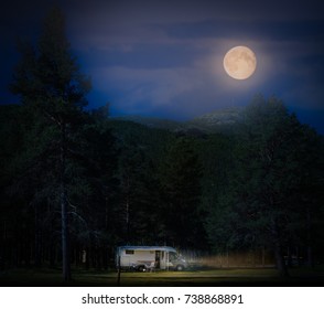 Recreational Vehicle At Night In Norway, Europe. Hills And Dark Cloudy Sky With Full Moon. Travel By RV. Nordic Country, Europe, Scandinavia.