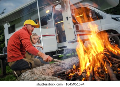 Recreational Vehicle RV Camper Camping and Family Time. Caucasian Father and His Daughter Hanging Next to Campfire on Their RV Park Pitch. Class C Motorhome in Background. - Shutterstock ID 1845951574