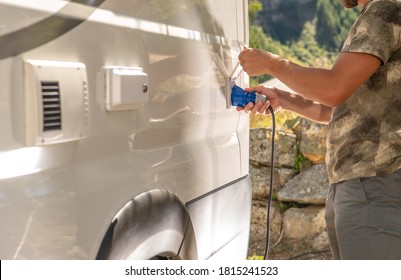 Recreational Vehicle RV Camper Van Camping Electricity Hookup Attaching to Motorhome Outlet by Caucasian Men.  - Shutterstock ID 1815241523