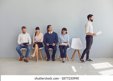 Recruitment Selection Process. Job Applicant Stands Up And Goes To HR Manager's Office While Other Worried, Nervous Candidates Are Waiting In Line Sitting On Chairs Outside The Interview Room