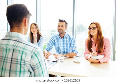 Recruitment. Three Corporate People Interview Young Man