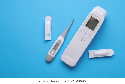 Rectal suppositories and thermometer on a blue background