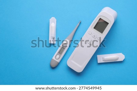 Rectal suppositories and thermometer on a blue background