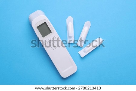 Rectal suppositories and thermometer on a blue background