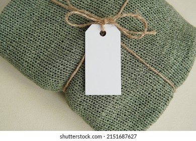 Rectangle Blank Tag Hanging On Handmade Knitted Sweater, Price Label Mockup, Hangtag Template For Design Presentation Or Text.