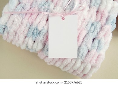 Rectangle Blank Tag Hanging On Handmade Knitted Baby Blanket, Price Label Mockup, Hangtag Template For Design Presentation Or Text.         