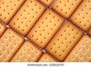 rectangle cookies stacked in rows. Close-up biscuit.  abstract golden texture background