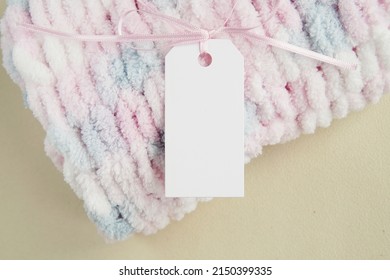 Rectangle Hangtag Mockup For Design Presentation On Handmade Knitted Product, Logo Label Template, Soft Baby Blanket With Pink Ribbon.