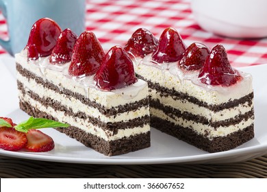 Rectangle Piece Of Cake With Strawberries On White Plate.