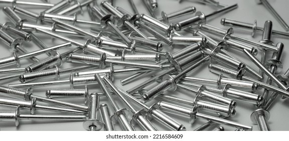 Rectangular Background With Aluminum Rivets On The Table. Sale Of Rivets In The Store.Traction Rivets For Fixing Sheets Of Iron.