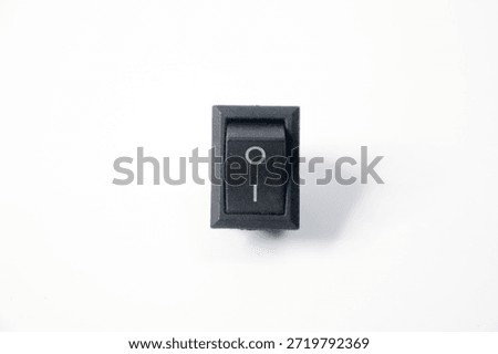 rectangular black plastic rocker switch with "I" (on) and "O" (off) markings, commonly used in electrical appliances and devices.