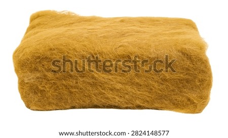 Rectangular block of yellow fibrous mineral wool insulation material