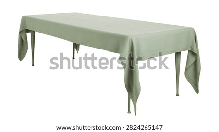 Rectangular dining table covered with a sage green linen tablecloth