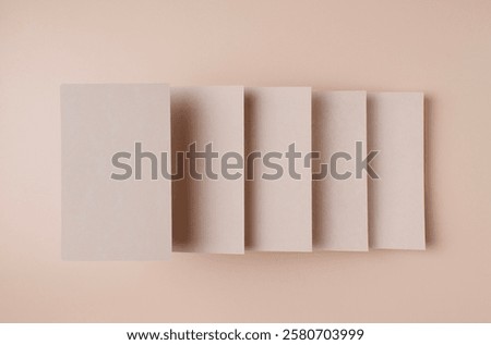 rectangular empty kraft cardboards, at different levels, form steps on a beige background, top view