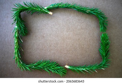 Rectangular frame made of green spruce branches. A clean New Year's background for congratulations.