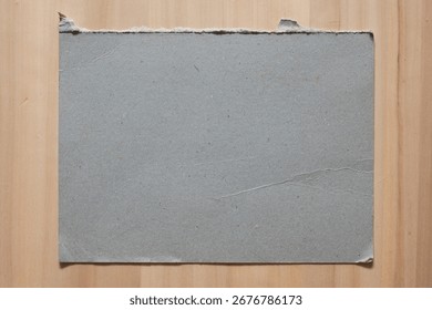 Rectangular gray hard board paper on wood table