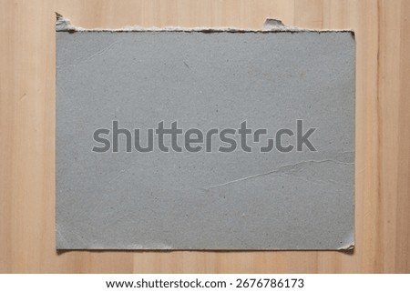 Rectangular gray hard board paper on wood table