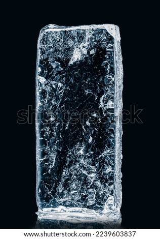 Rectangular ice block, with cracks and air bubbles inside, isolated on black background. Clipping path included.