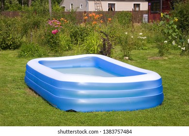 Rectangular Inflatable Blue Swimming Pool On A Green Lawn