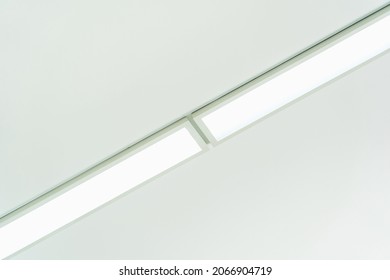 Rectangular LED lights on a white ceiling