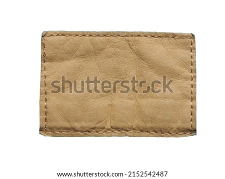 rectangular light brown leather nameplate on white background isolated from the leather lable of jeans