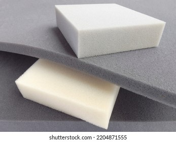 rectangular pieces of gray and white foam sponge neatly stacked. materials with different thickness