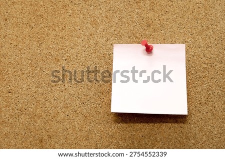 A rectangular pink note is attached to a brown cork bulletin board with a red pin, indicating it is an announcement or warning message.