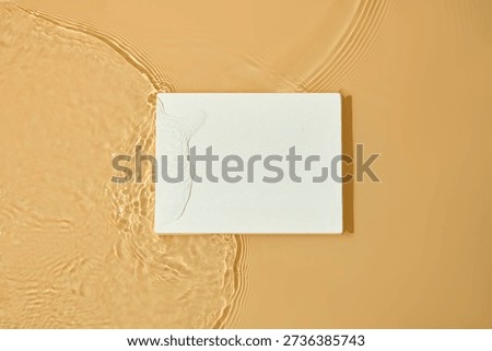 Rectangular podium resting on textured warm surface with subtle water marks. Simple and structured background for product placement or graphic layouts