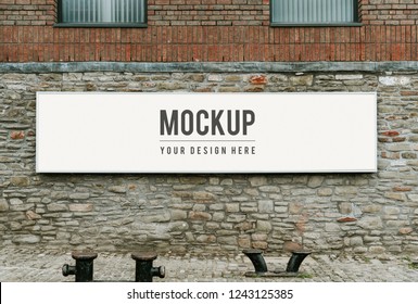 Rectangular public signage mockup on a brick wall