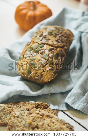 Similar – Image, Stock Photo rustic seeded bread, wrapped in striped fabric