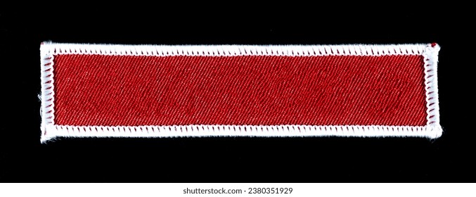 Rectangular red patch with white trim.
