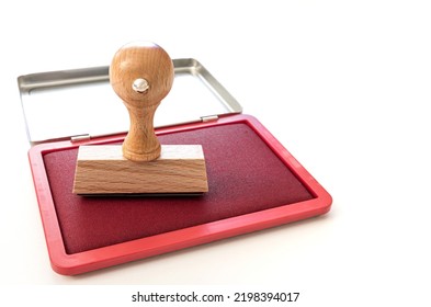 Rectangular Rubber Stamp On Ink Pad On White Desk