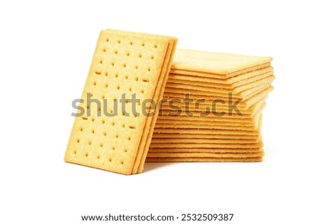 Rectangular, savory salty cheese-flavored biscuits with a golden-yellow color, neatly stacked. Perfect as a snack. Photographed on a white background.