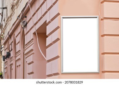 Rectangular sign on the building. Copy space and space for text. Mockup for design. Blank template for advertising. White frame on the facade of the house. Advertising on architecture.