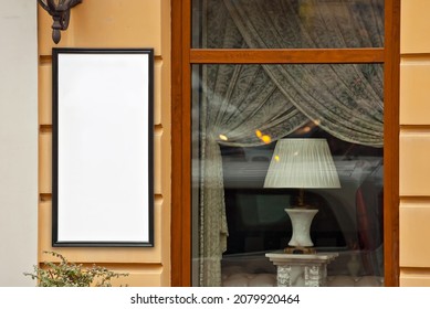 Rectangular Sign On The Building. Copy Space And Space For Text. Mockup For Design. Blank Template For Advertising. White Frame On A Glass Case. Advertising On The Window Of A Restaurant Or Shop.