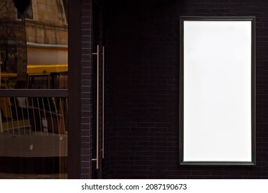 Rectangular Sign On The Building. Copy Space And Space For Text. Mockup For Design. Blank Template For Advertising. White Frame On A Glass Case. Advertising On The Window Of A Restaurant Or Shop.